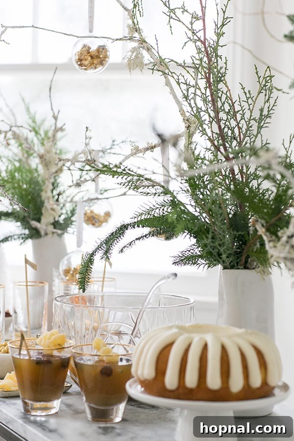 A festive arrangement of cocktails alongside a beautifully decorated bundt cake, perfect for a holiday gathering