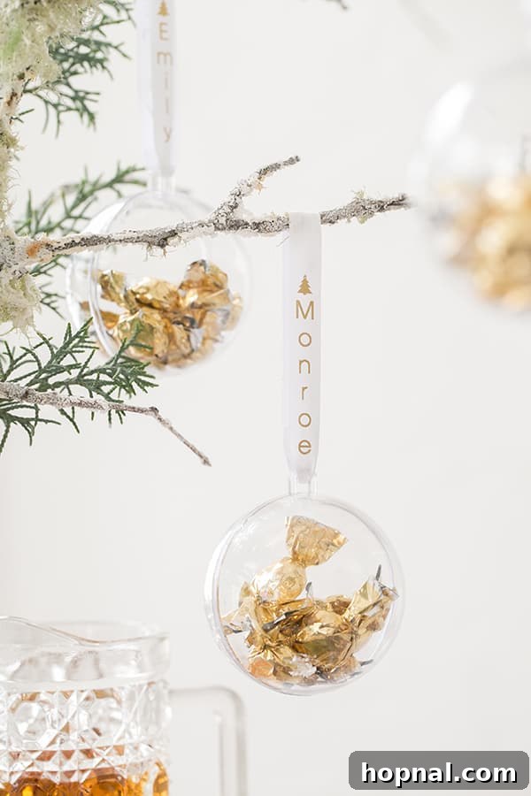 A shimmering bauble ornament, delicately hanging from a festive branch, reflecting holiday lights