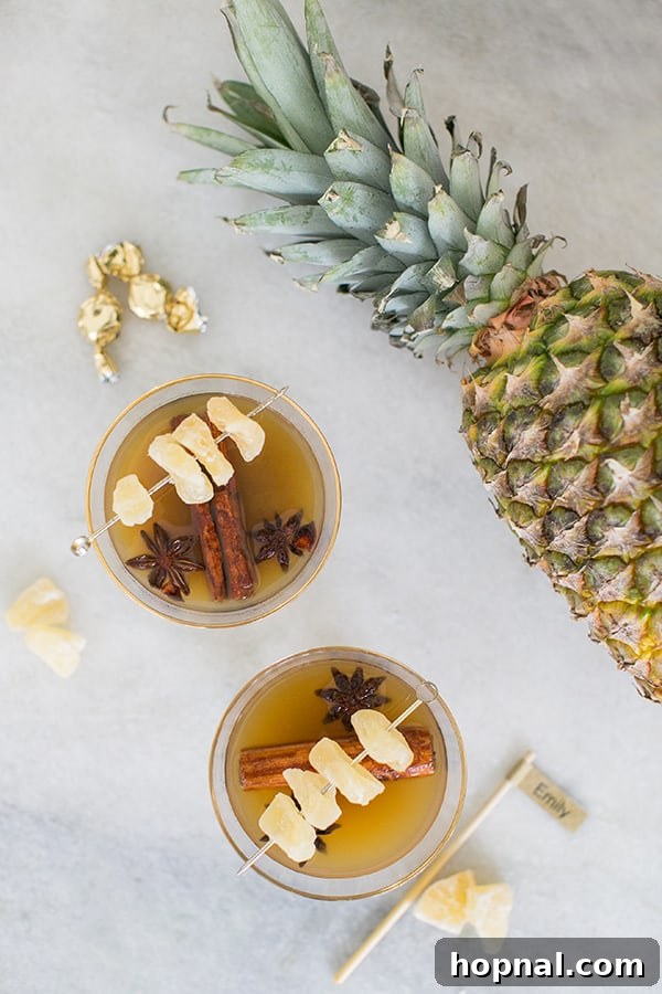 Close-up of individual cocktails neatly arranged on a holiday drink station, showcasing festive garnishes and inviting presentation