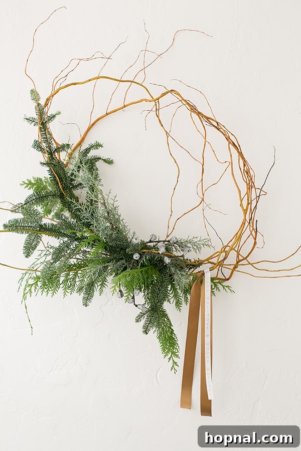 An elegantly asymmetrical holiday wreath, adorned with a custom 'Happy Holidays' ribbon, adding a unique festive touch