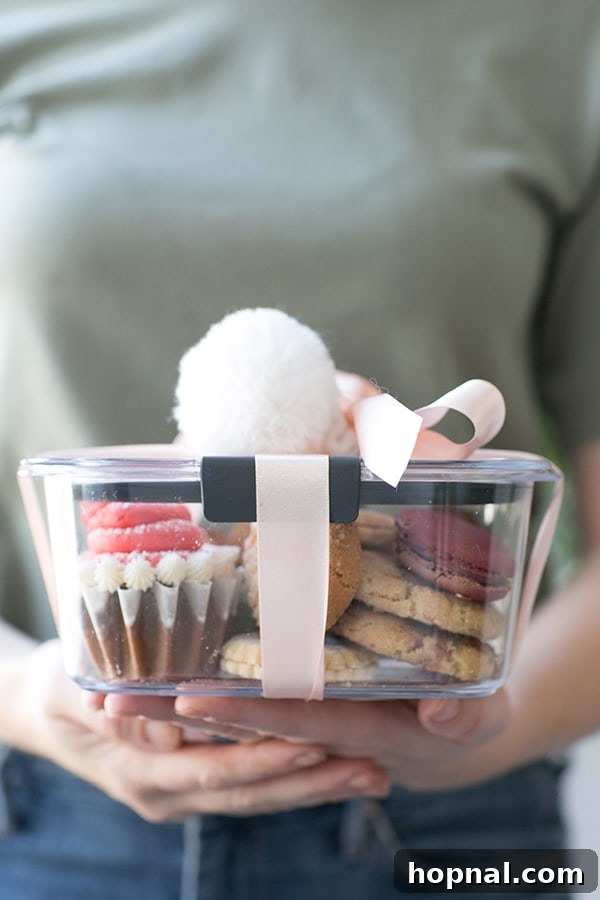 A beautifully wrapped take-away container, secured with twine and a festive tag, filled with cookies from a successful cookie swap.