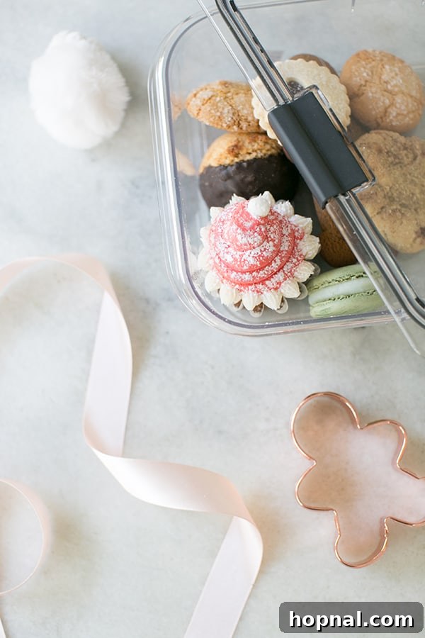 Assorted festive cookies neatly packed into a decorative take-away container, tied with a ribbon, ready to be gifted or enjoyed at home.
