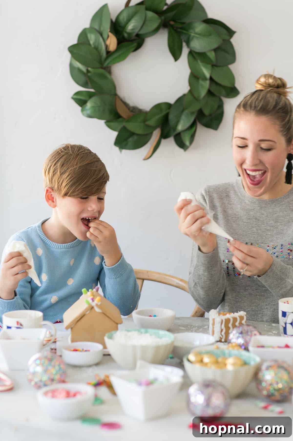 Your Ultimate Guide to an Epic Gingerbread House Decorating Party 5 eden and romeo having fun at the diy gingerbread house party - cute little gingerbread house, milk cartons