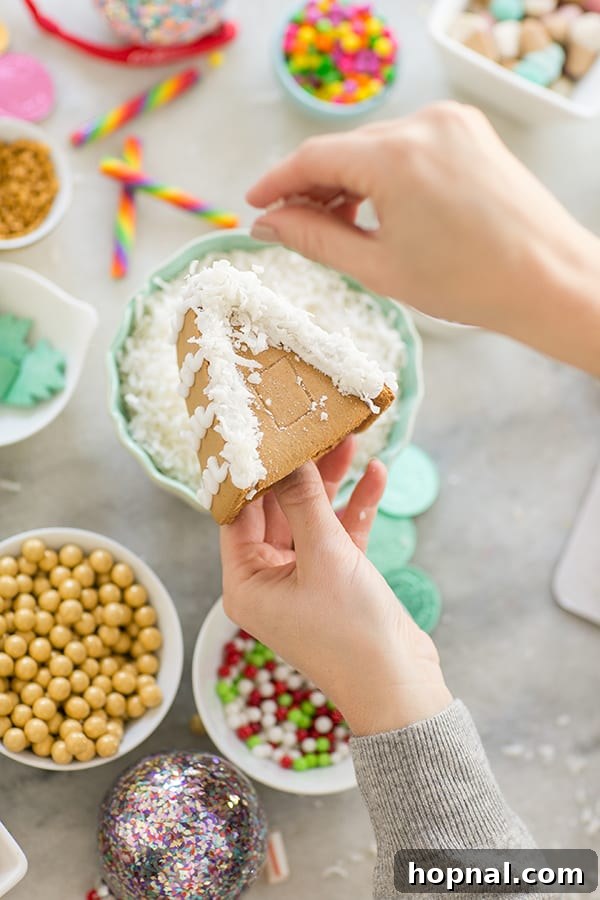 Your Ultimate Guide to an Epic Gingerbread House Decorating Party 9 shot of diy gingerbread house roof being decorated - royal icing, muffin tins