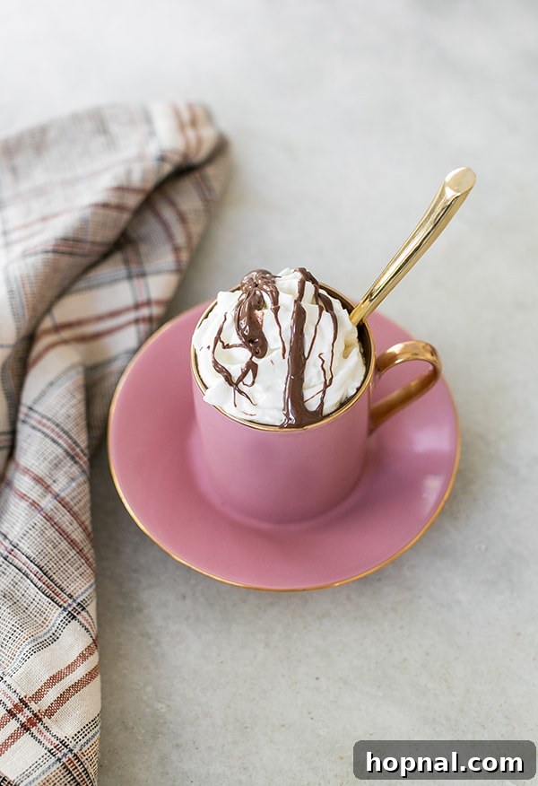 Hazelnut Cocoa Indulgence 3 A beautifully crafted hazelnut coffee, topped generously with fluffy whipped cream and a delicate drizzle of melted chocolate, inviting a blissful sip.
