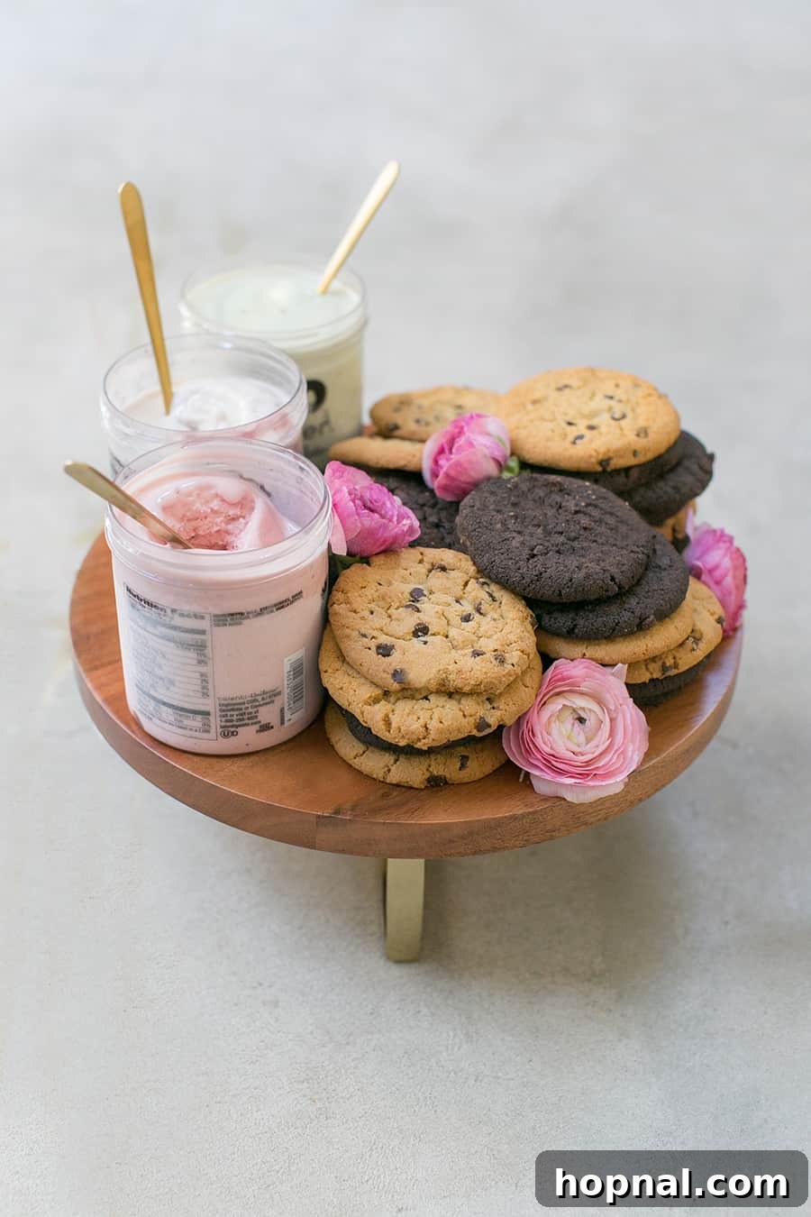 A vibrant platter featuring a variety of ice cream and cookies, inviting guests to create their own custom ice cream sandwiches for a happy Galentine's Day party.