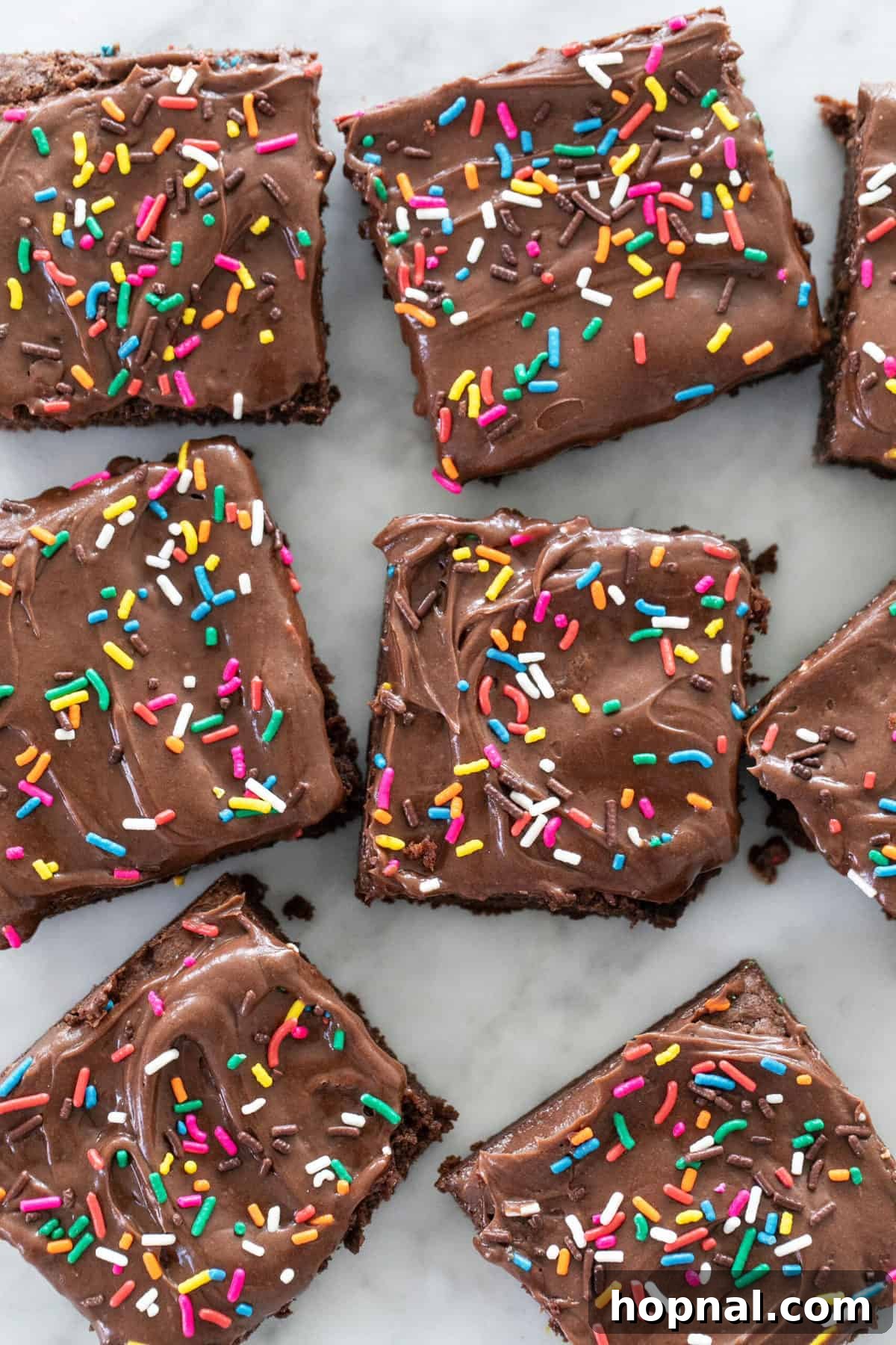 Rich chocolate fudge brownies topped with creamy whipped sour cream frosting, an irresistible dessert.