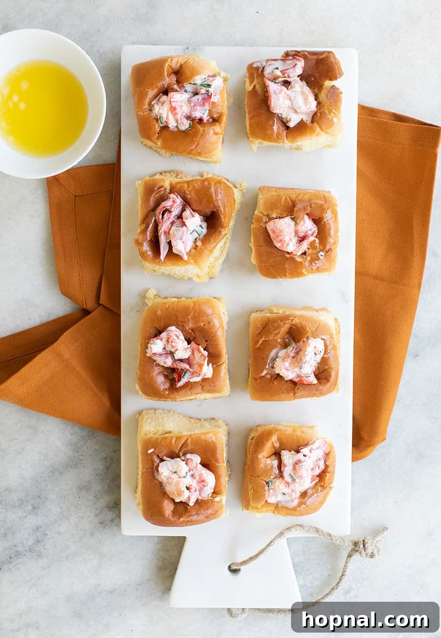 Mini lobster rolls served on fluffy Hawaiian rolls, a luxurious yet easy game day appetizer.