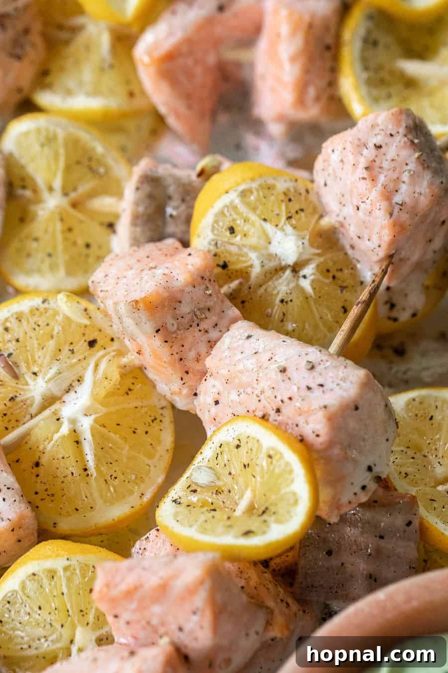 Flavorful salmon skewers garnished with fresh herbs, perfect for a light and healthy game day option.