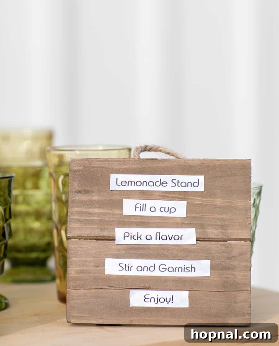A charming, custom-made wooden sign prominently displayed on a lemonade stand, inviting guests to enjoy 'Lemonade & Libations'.