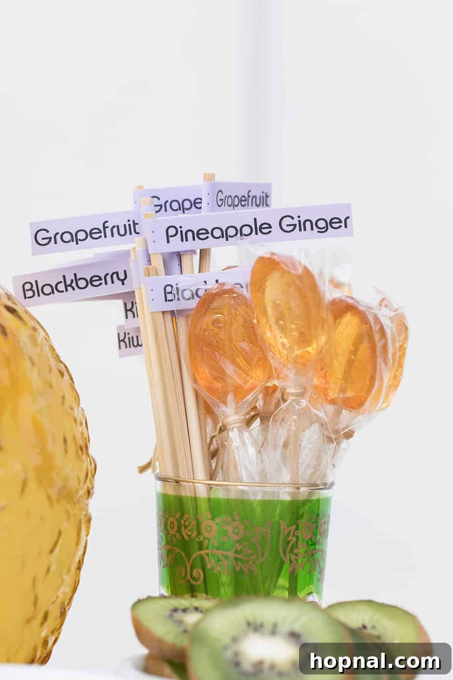 A display of various simple syrups in elegantly labeled glass bottles, clearly indicating flavors like kiwi, grapefruit, and blackberry, for a self-serve bar.