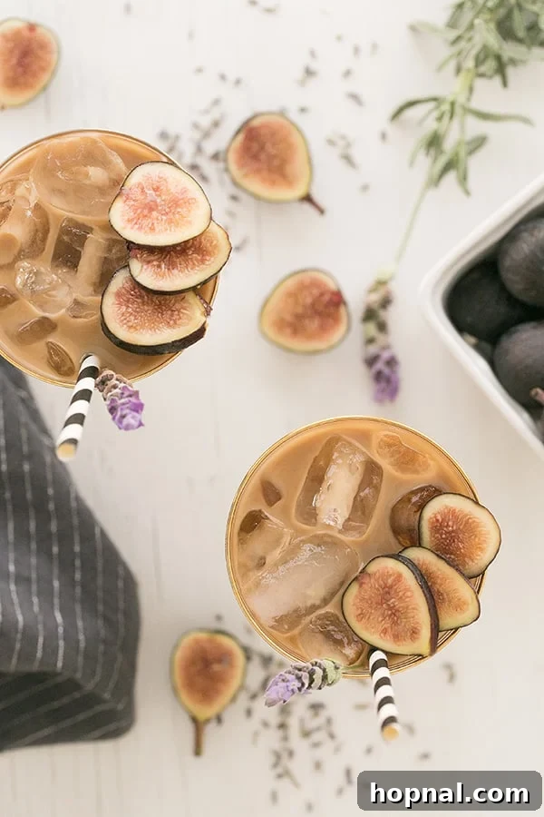 Top-down view of a glass filled with easy cold brew coffee, garnished with fresh figs and a sprig of lavender.