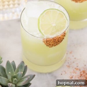 A beautifully crafted honeydew margarita recipe, garnished with fresh honeydew and lime.