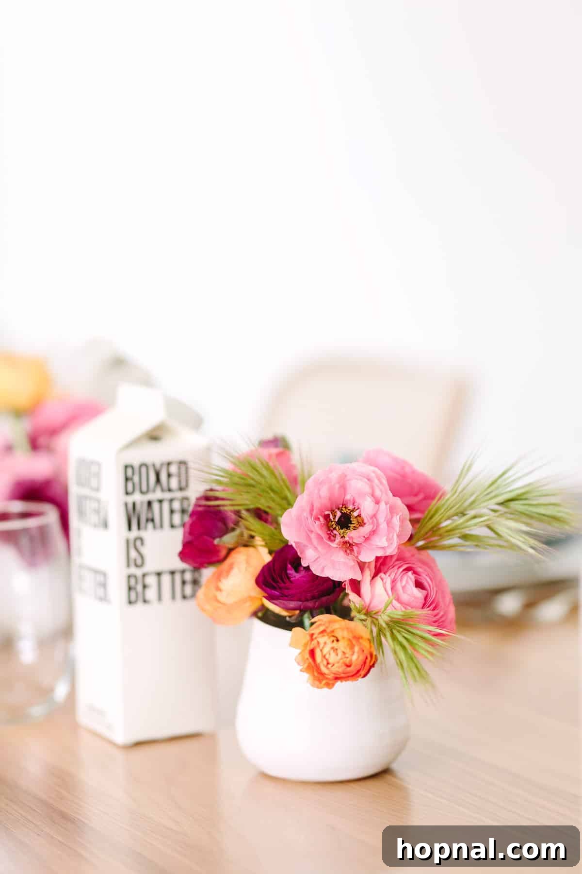 Planting Seeds for Success: A ScholarShare 529 Spring Brunch 9 Guest holding a boxed water next to a place setting