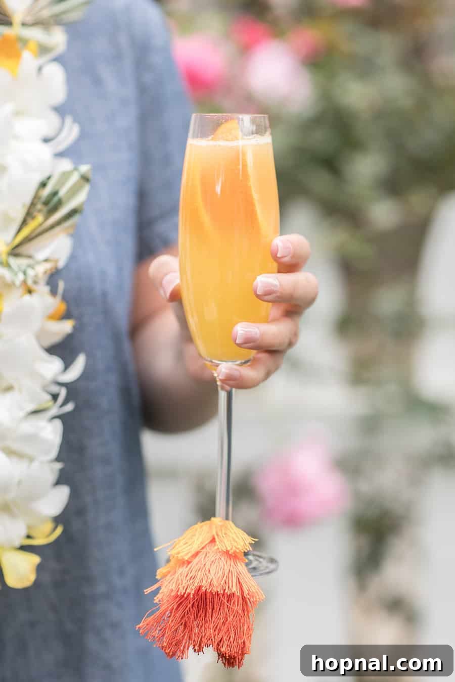 Holding a mimosa with a colorful tassel