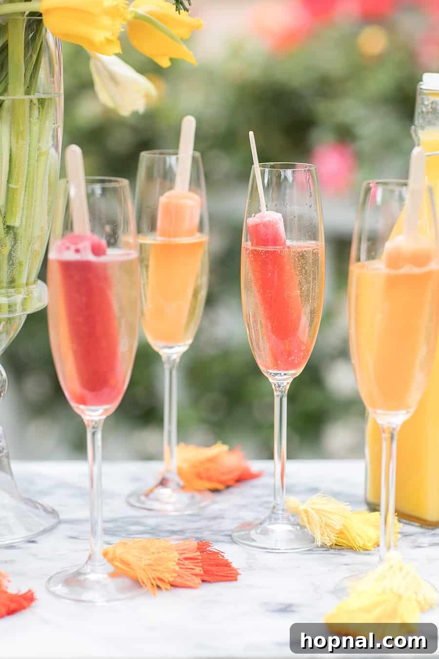 Popsicles in glasses filled with Champagne