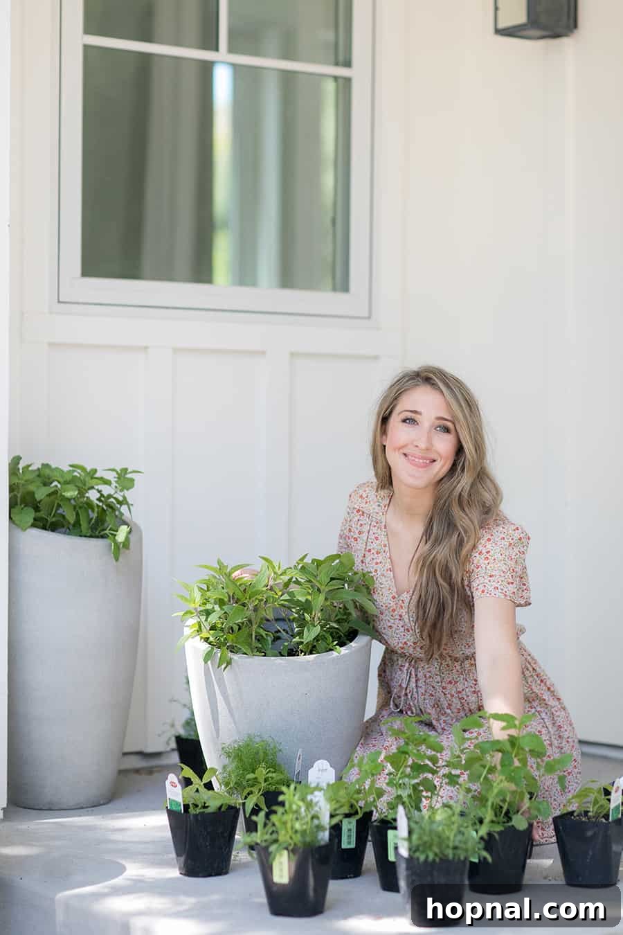 Eden Passante planting fresh herbs on her side porch for a tea garden project, demonstrating the initial steps of setting up a functional and beautiful space.