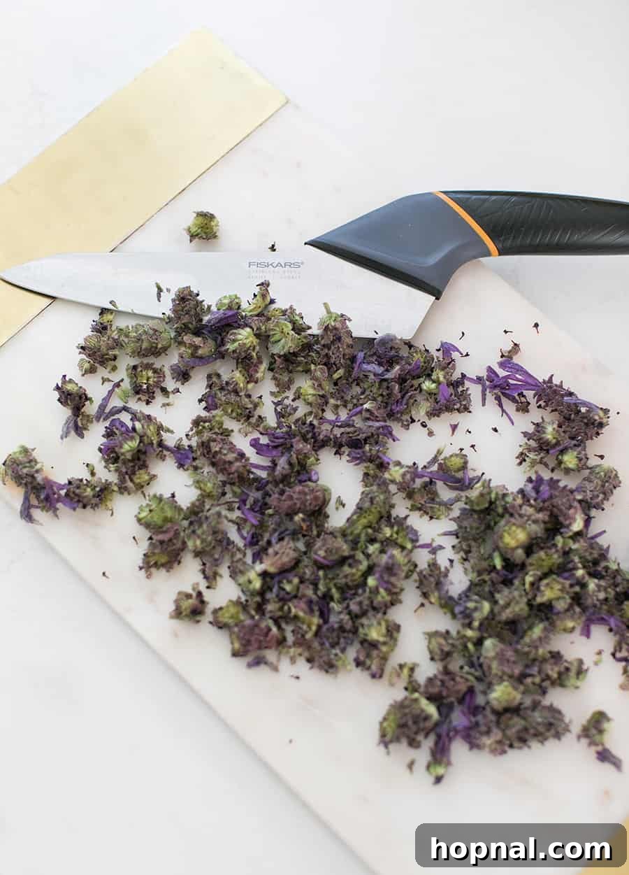 A luxurious swirl of rich dark chocolate ganache being whisked to a perfectly smooth and glossy consistency after the lavender-infused cream has been added.