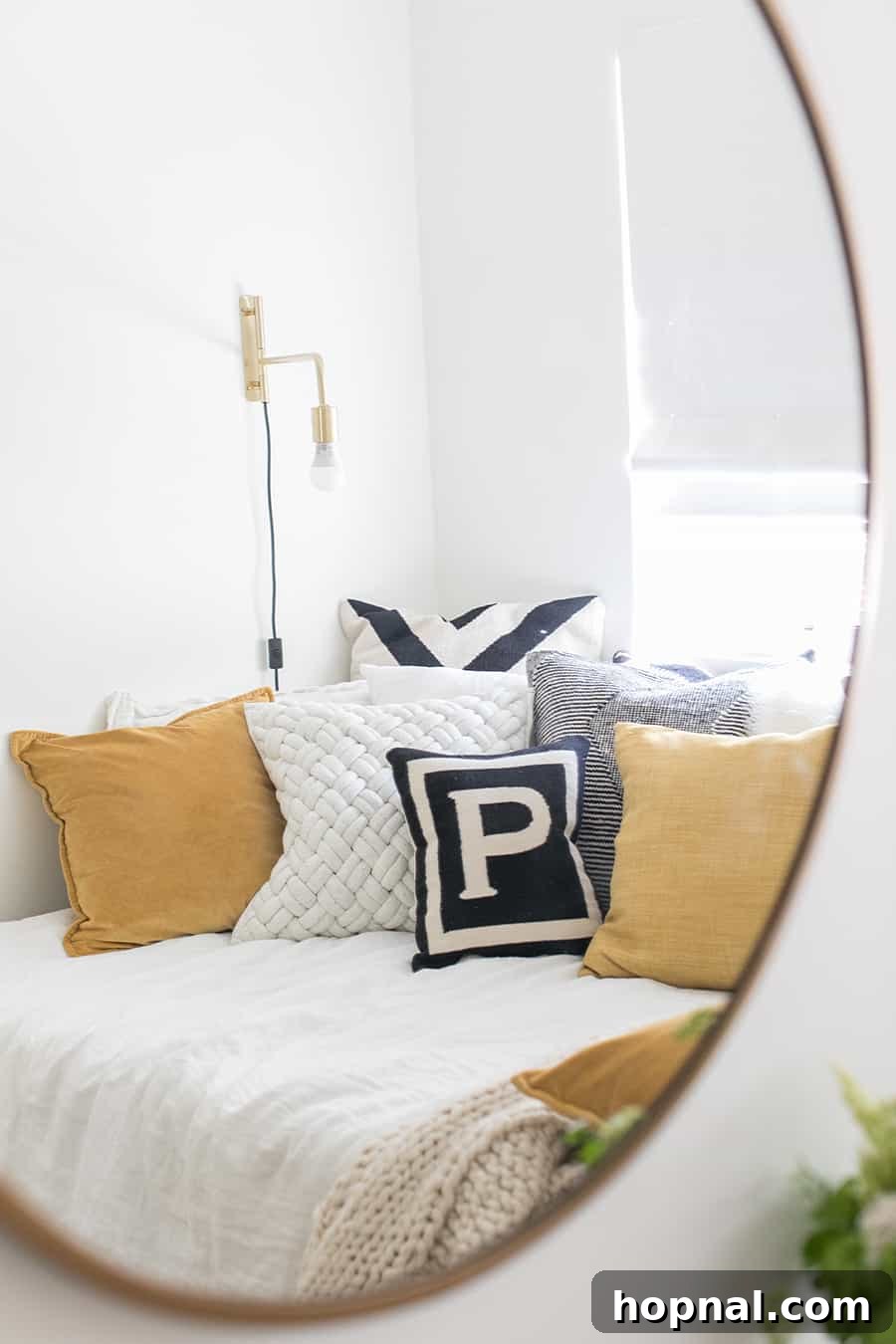Designing a Welcoming Guest Room Oasis 15 Photo in a mirror with pillows and gold light