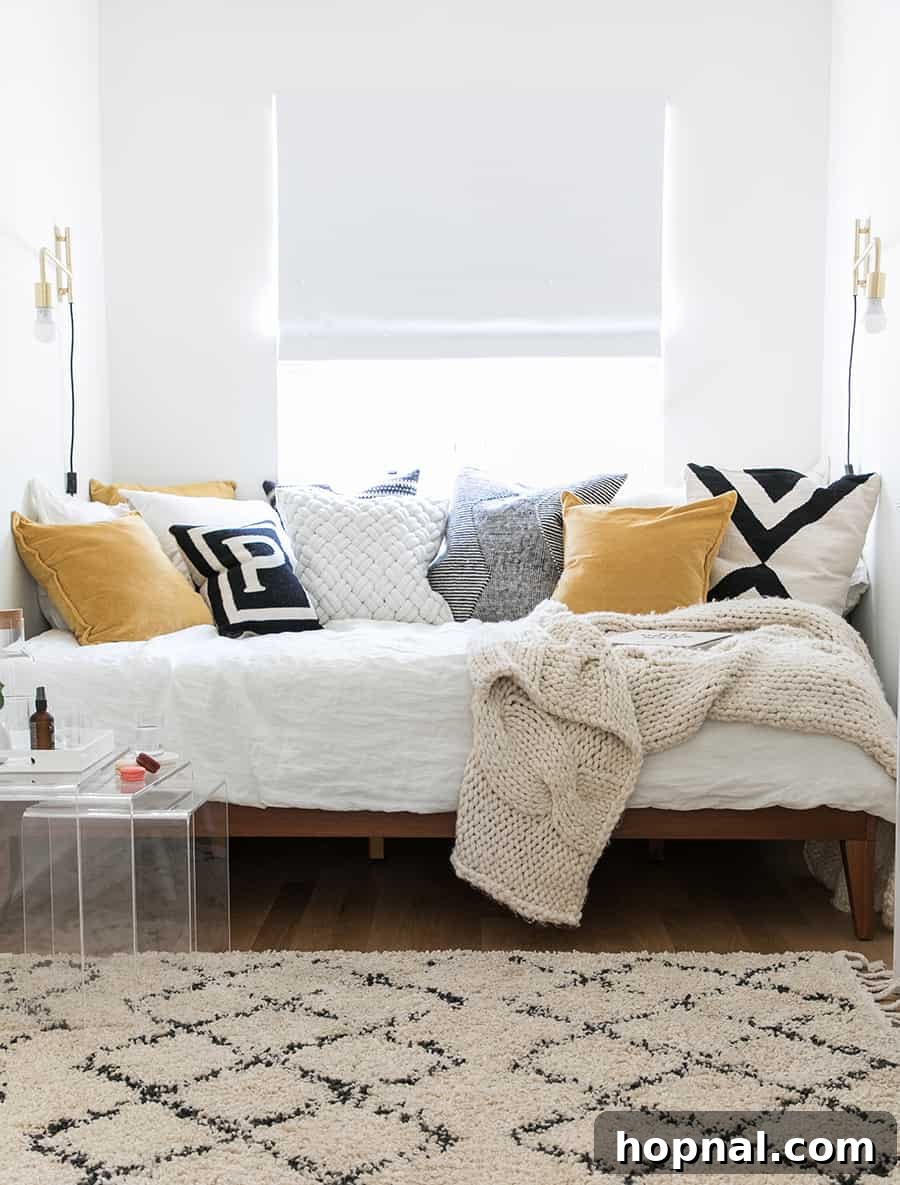 Designing a Welcoming Guest Room Oasis 16 a picture of a bed with a lot of pillows.