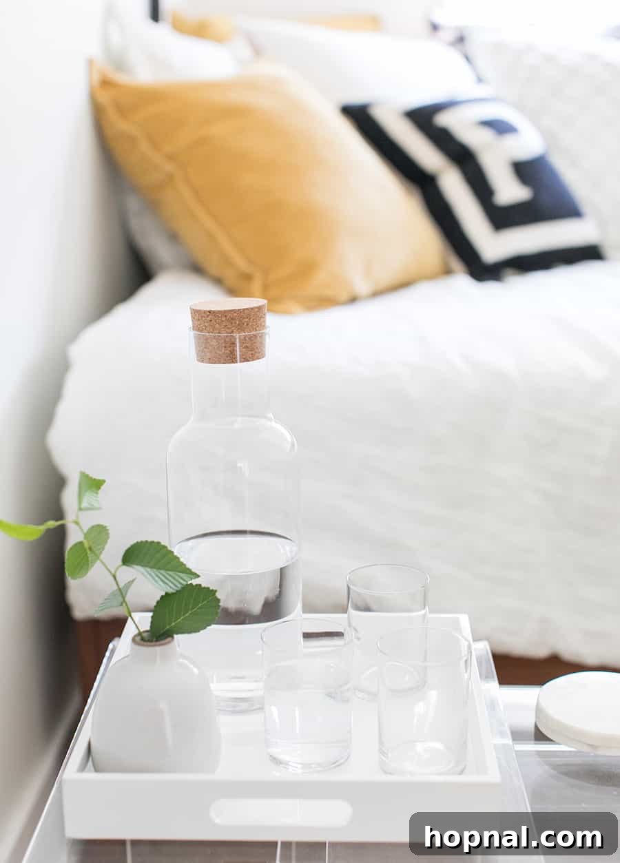 Designing a Welcoming Guest Room Oasis 6 Water and cups next to a bed.