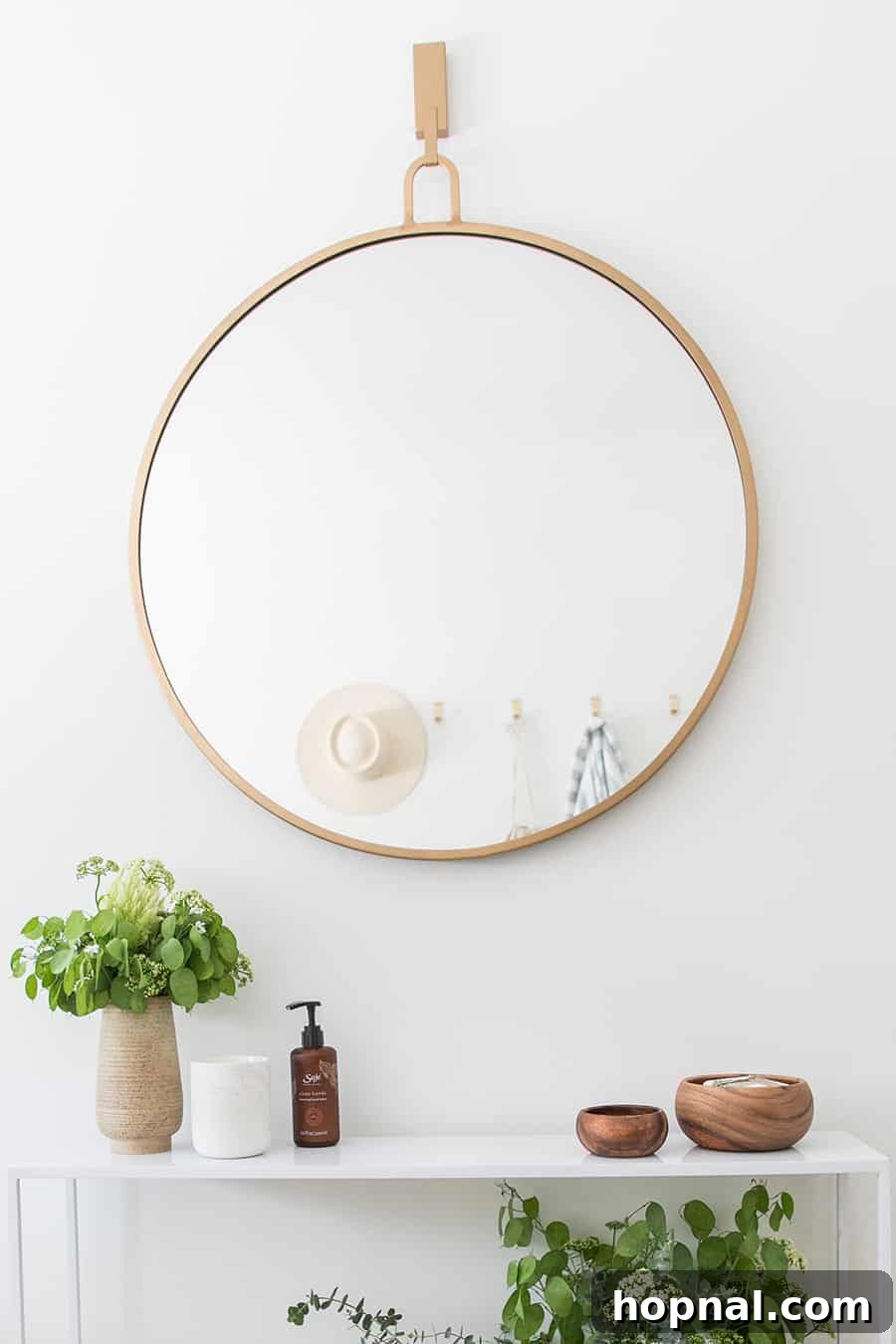 Designing a Welcoming Guest Room Oasis 10 Large gold mirror with flowers and plants