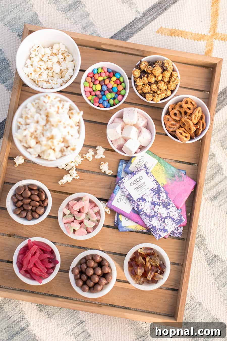 Lights, Camera, Backyard: Your Outdoor Movie Night Guide 11 A popcorn bowl brimming with popcorn, mixed with chocolate pieces and crunchy pretzels for a delightful movie snack.