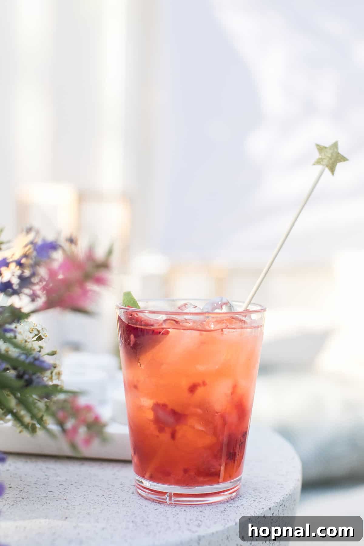 Lights, Camera, Backyard: Your Outdoor Movie Night Guide 14 A close-up of a strawberry soda garnished with a star stir stick, adding a festive touch to the drink.