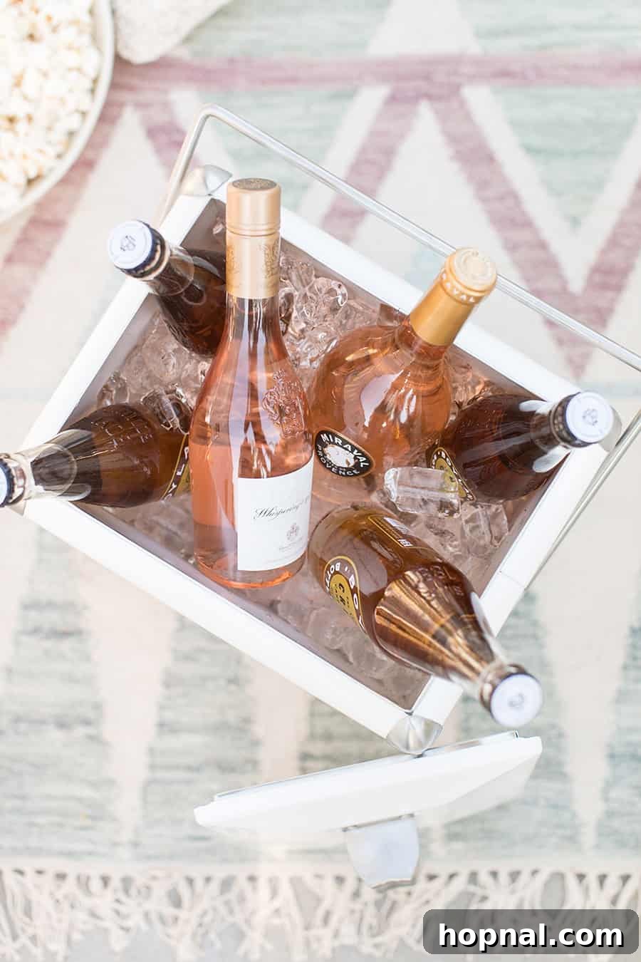 Lights, Camera, Backyard: Your Outdoor Movie Night Guide 15 A cooler brimming with ice and bottles of rosé wine, ready to keep drinks perfectly chilled during an outdoor gathering.