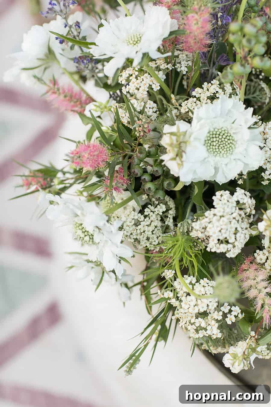 Lights, Camera, Backyard: Your Outdoor Movie Night Guide 8 A close-up photograph highlighting fresh flowers and lush green foliage, adding natural beauty to the outdoor decor.
