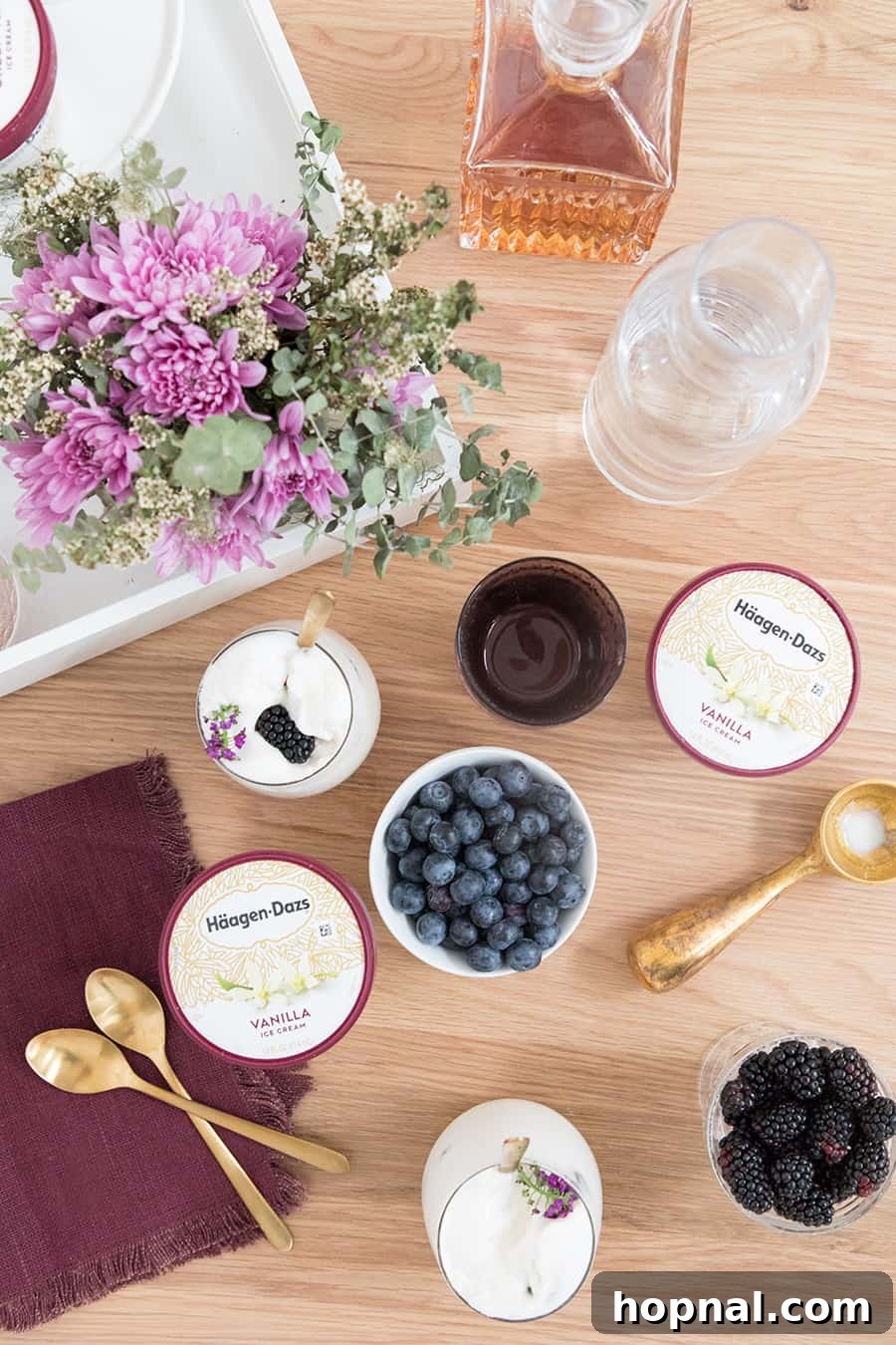 over head of ice cream and berries to make boozy ice cream floats