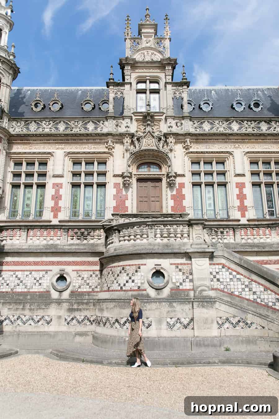 Visitor exploring the grand architecture of Palais Bénédictine in Fécamp, Normandy