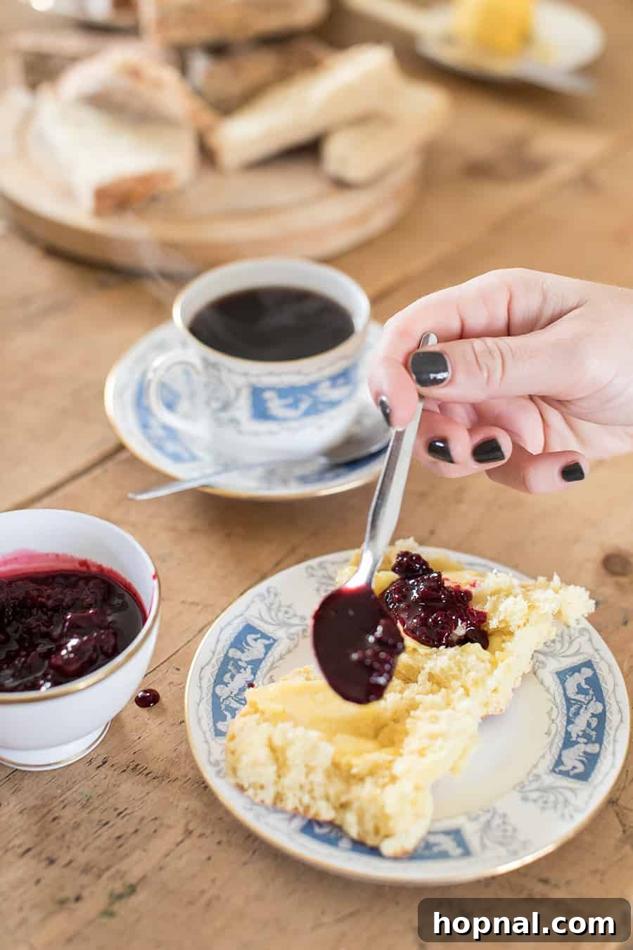 Master the Art of Irish Soda Bread 12 Spooning homemade berry jam onto a fresh piece of Irish soda bread, ready to be enjoyed.