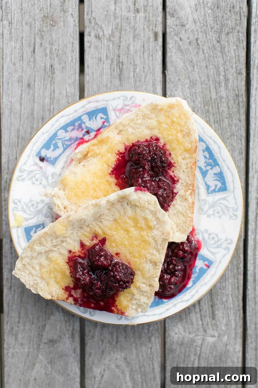 Master the Art of Irish Soda Bread 13 A plate of freshly baked Irish soda bread with a generous spread of butter and homemade jam, invitingly presented.