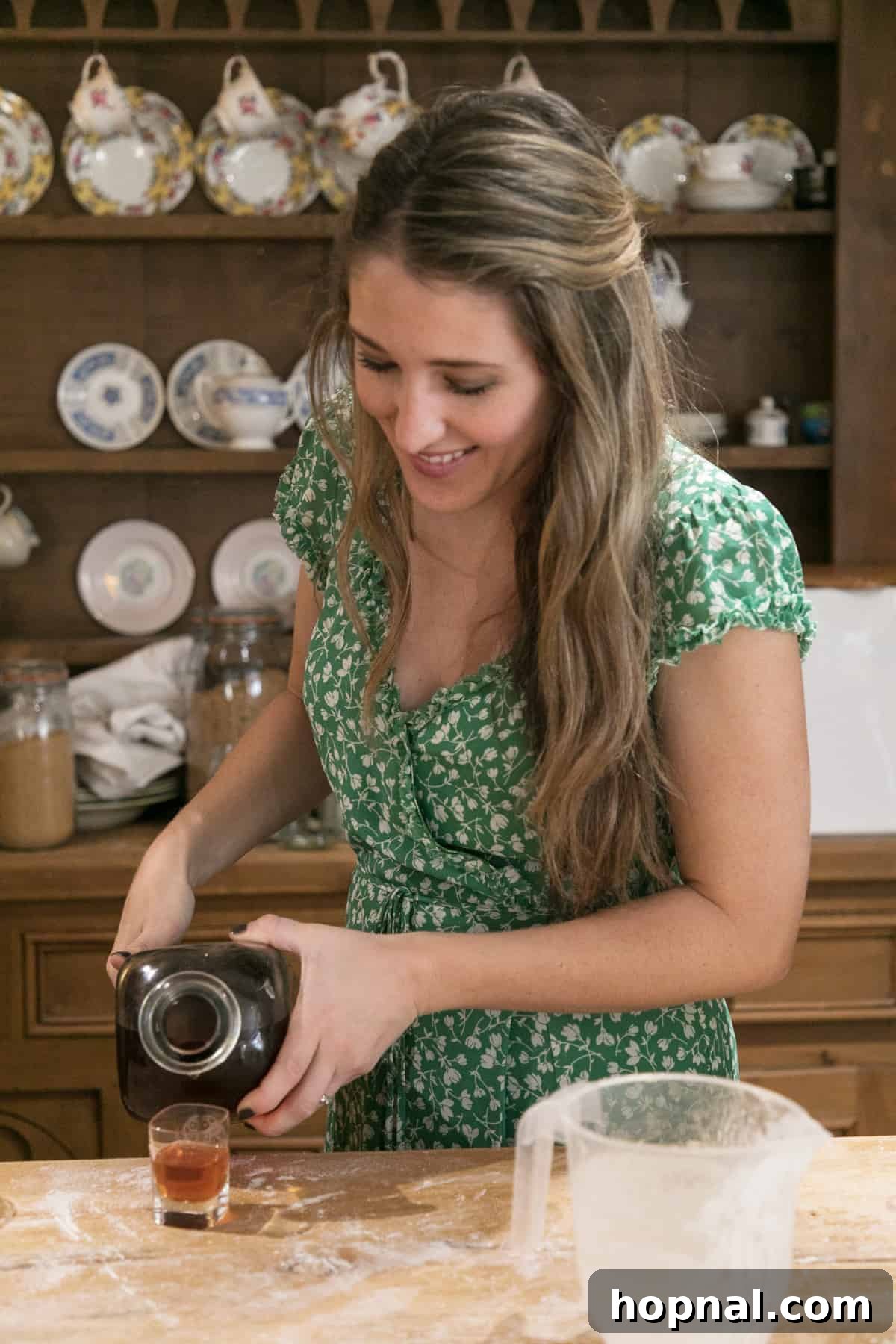 Master the Art of Irish Soda Bread 14 Pouring vibrant berry-infused gin into a small shot glass, a delicious homemade Irish spirit.