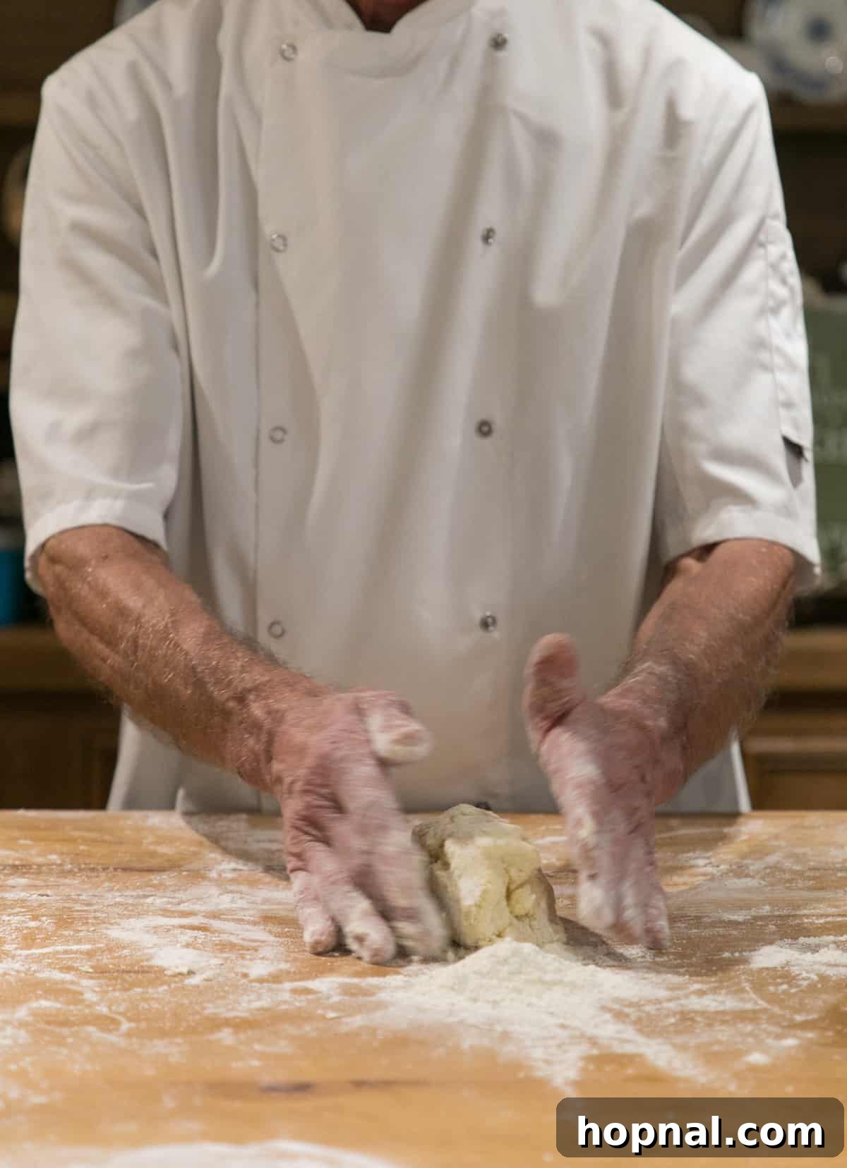 Master the Art of Irish Soda Bread 7 An Irish man's hands expertly kneading and shaping dough for traditional Irish soda bread on a wooden surface.