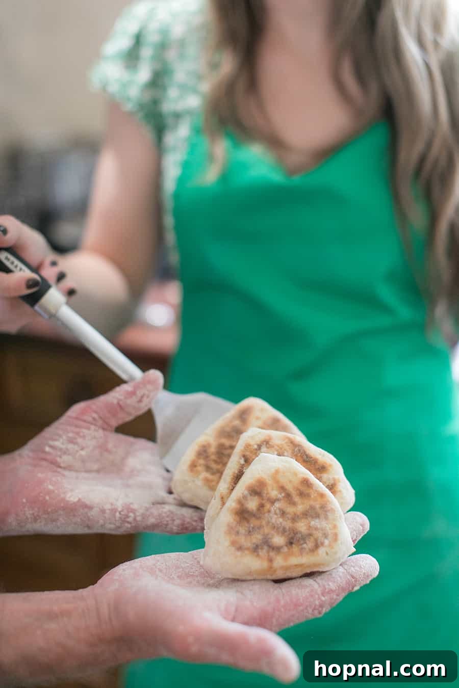 Master the Art of Irish Soda Bread 9 A hand holding a freshly baked, warm piece of traditional Irish soda bread, showcasing its rustic texture.
