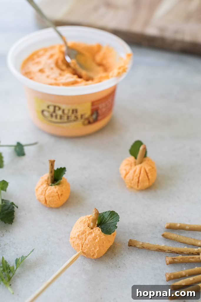 Cheese pumpkin balls to put on a Halloween charcuterie board.