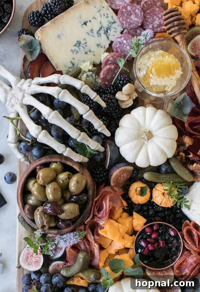 Festive Halloween meat and cheese board with prosciutto and various elements.