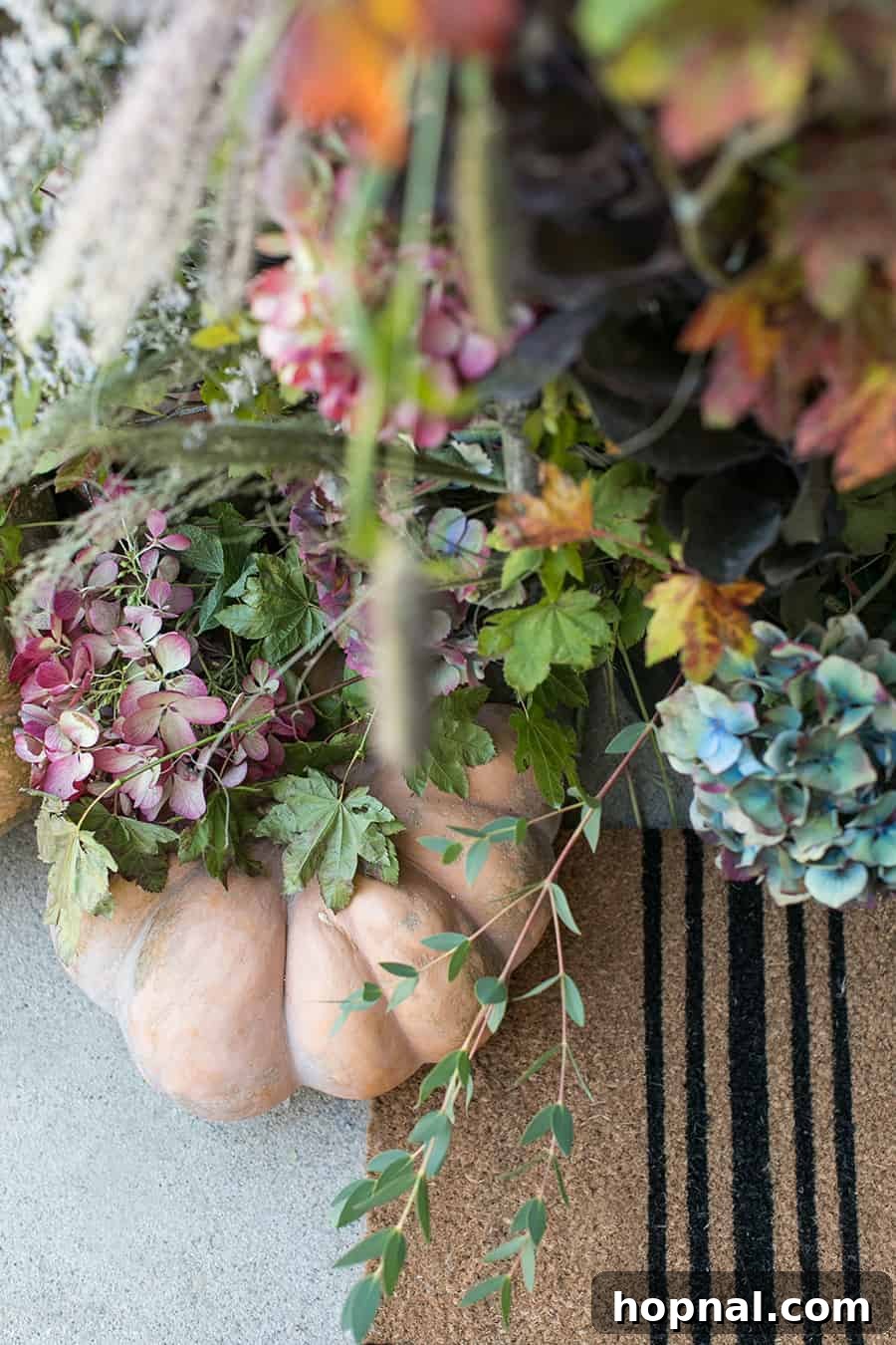 flowers and pumpkins on front porch