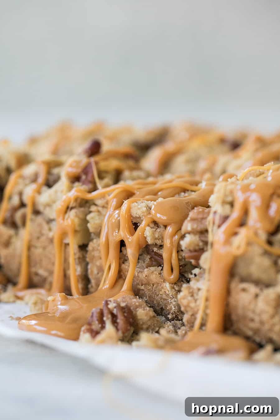 Ultimate Caramel Apple Crumble Bars 3 Close-up of baked crumble bars, showcasing the apple layers and golden, crunchy topping, ready for caramel.