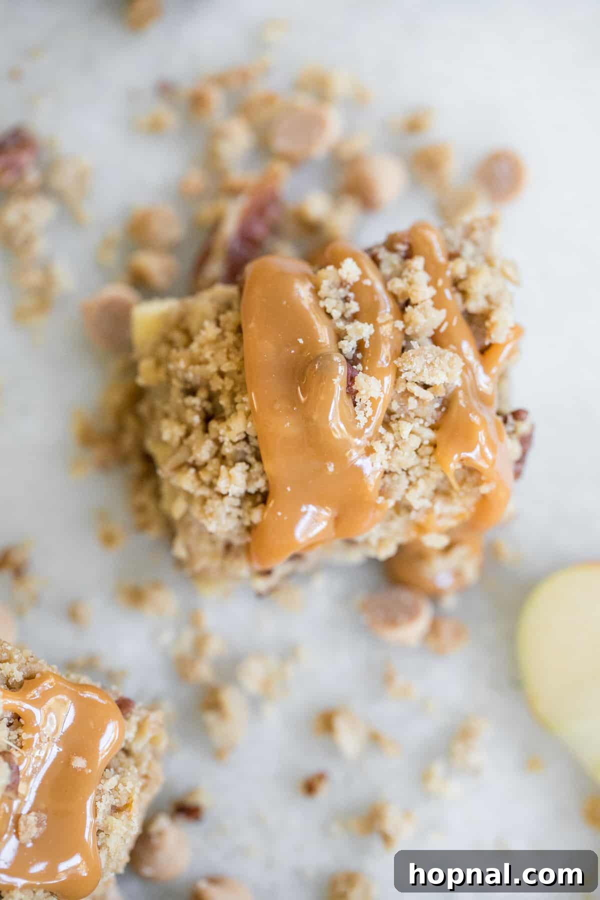 Ultimate Caramel Apple Crumble Bars 6 A single caramel apple crumble bar, freshly baked and generously drizzled with caramel sauce.