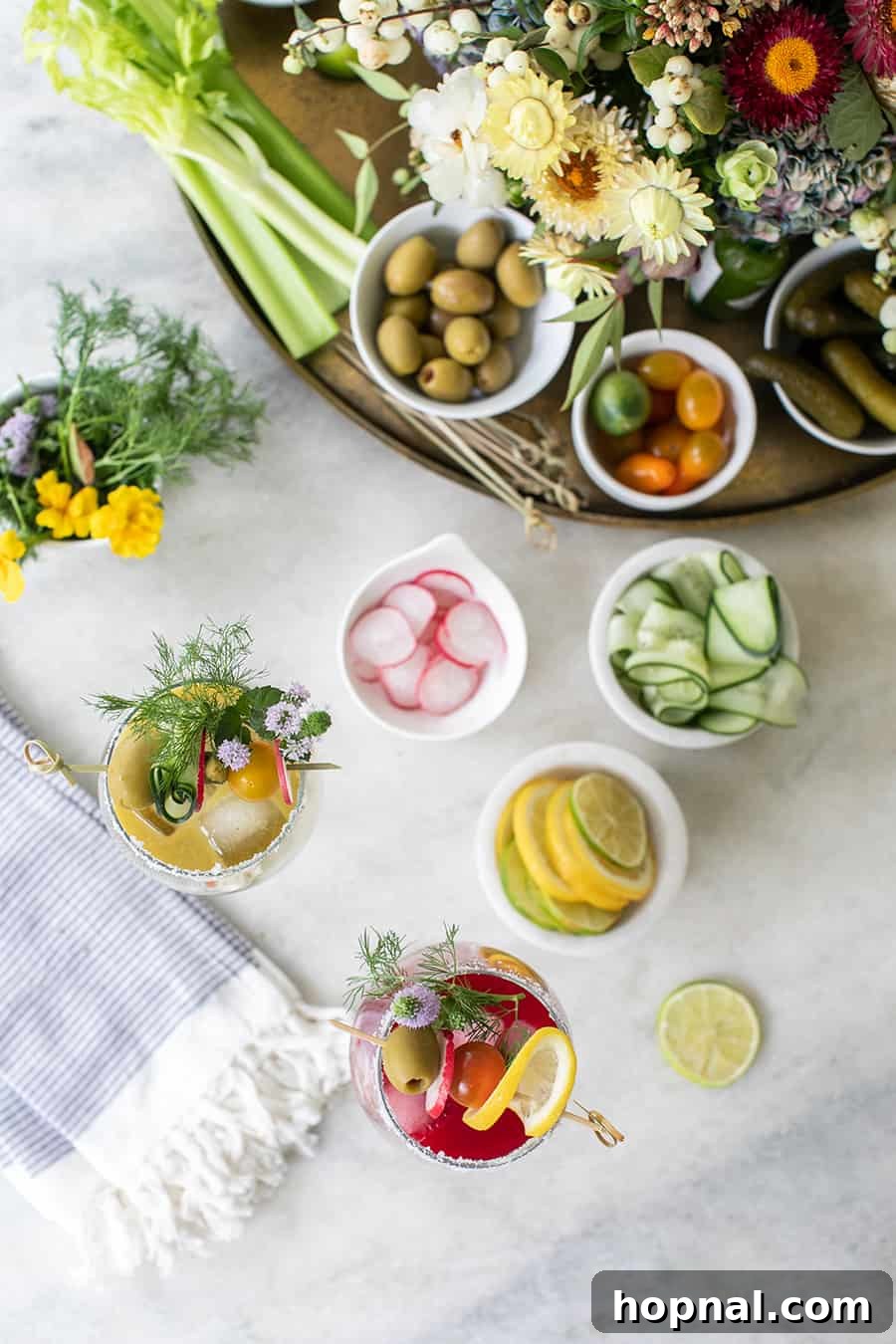 Craft Your Ultimate Home Bloody Mary Bar 16 Overhead photo of a well-appointed Bloody Mary bar set up on a sophisticated marble table.