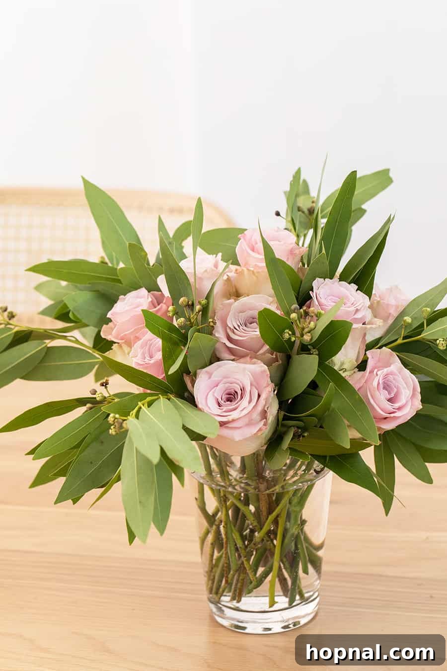 Twin Rose Elegance 6 Beautiful side shot of pink roses elegantly arranged in a glass vase