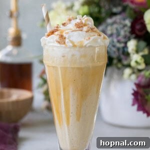 Caramel Coffee Milkshake with whipped cream and caramel drizzle in a glass.