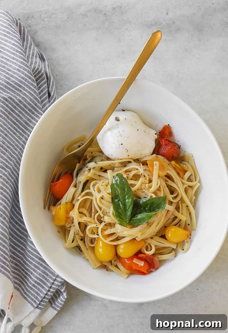 Delicious One Pan Basil and Tomato Pasta served in a bowl, garnished with fresh basil leaves and halved cherry tomatoes.