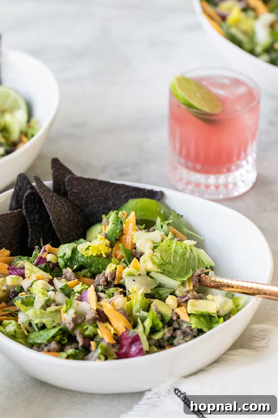 Southwest Fiesta Salad 6 A beautifully presented taco salad bowl, accompanied by crunchy blue tortilla chips and refreshing margaritas.