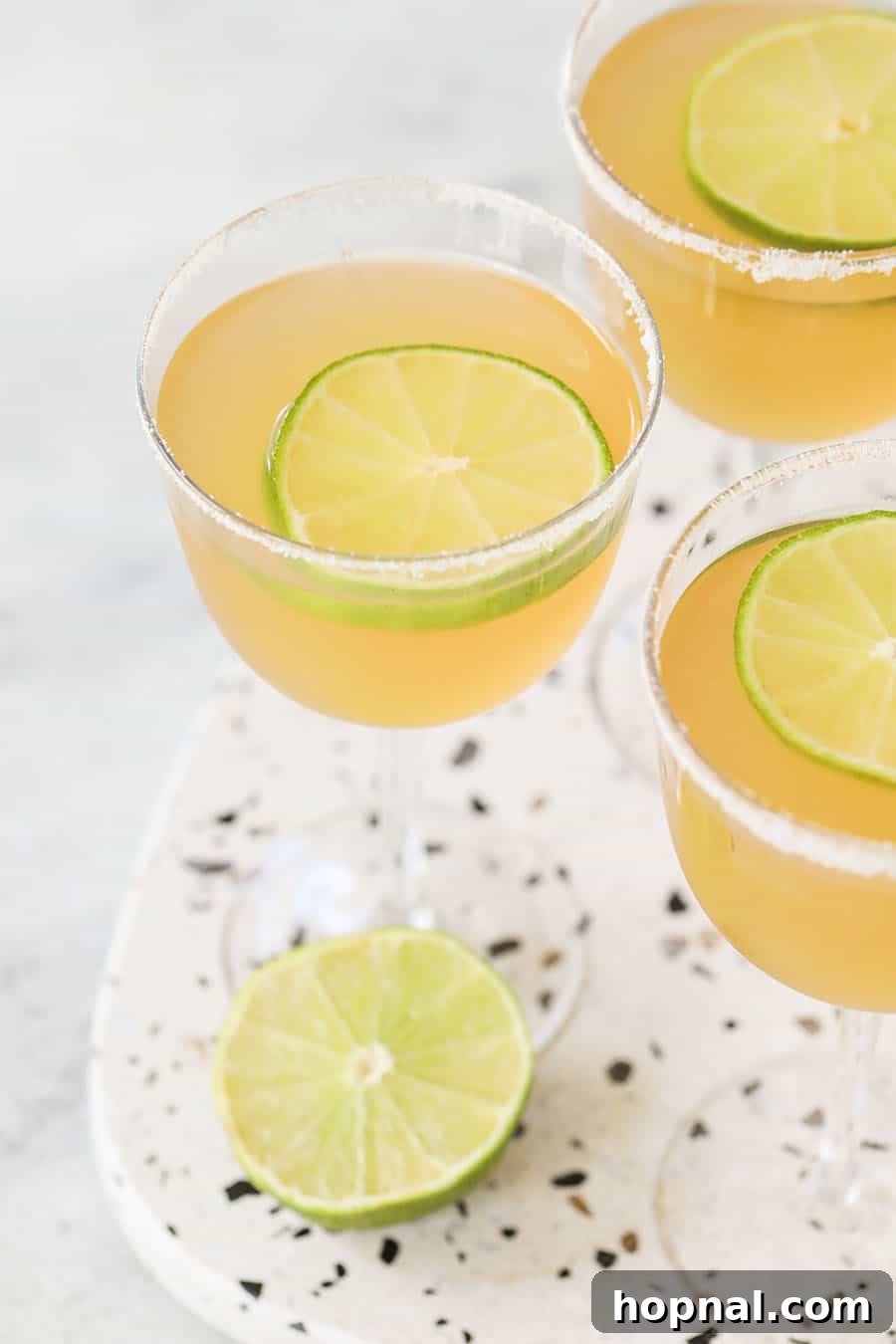 Classic Three-Ingredient Daiquiri 3 A classic three-ingredient daiquiri recipe presented on a sleek marble table.