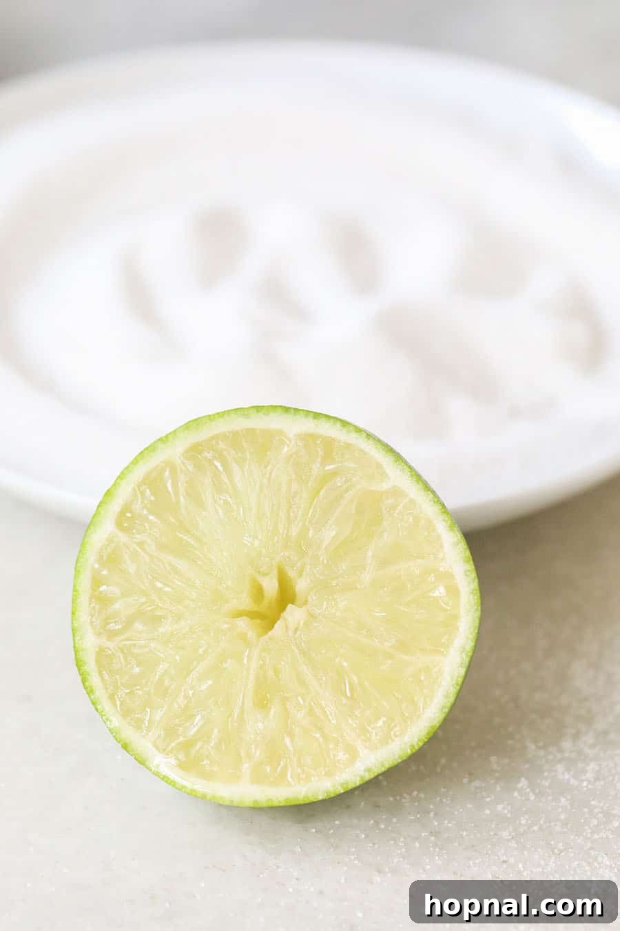 Classic Three-Ingredient Daiquiri 5 Lime slices and sugar on a marble table, ready for daiquiri garnish.