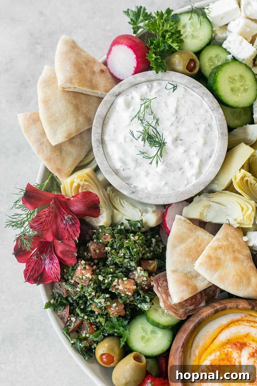 Beautiful homemade Greek mezze board showcasing an array of colorful dips and vegetables, ready for serving.